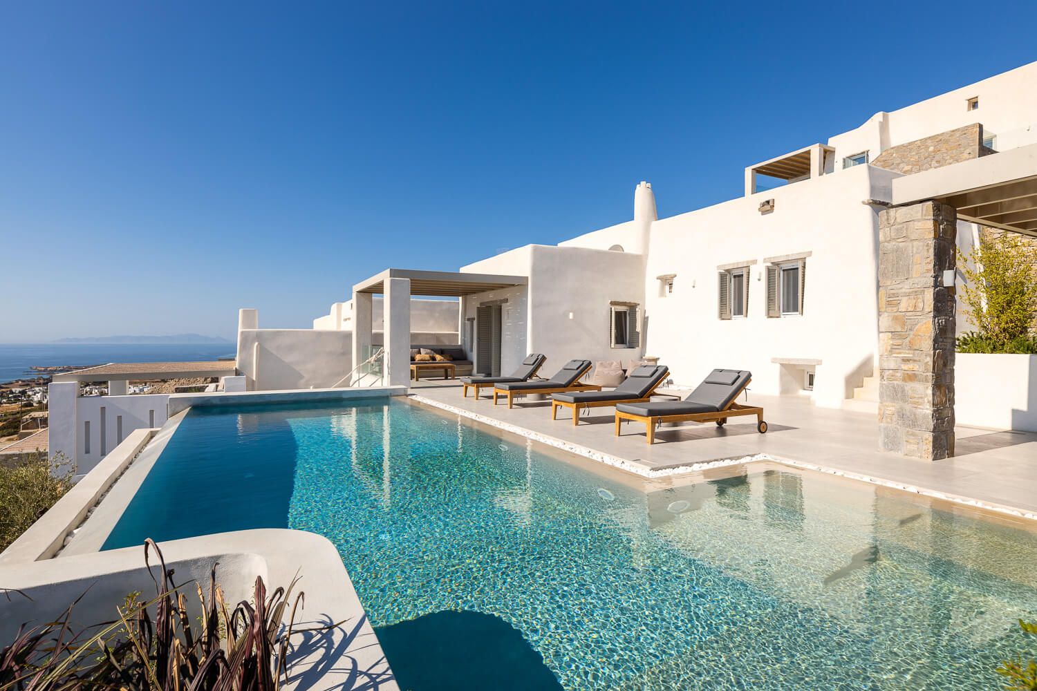 Clean architectural lines framing the cycladic sky