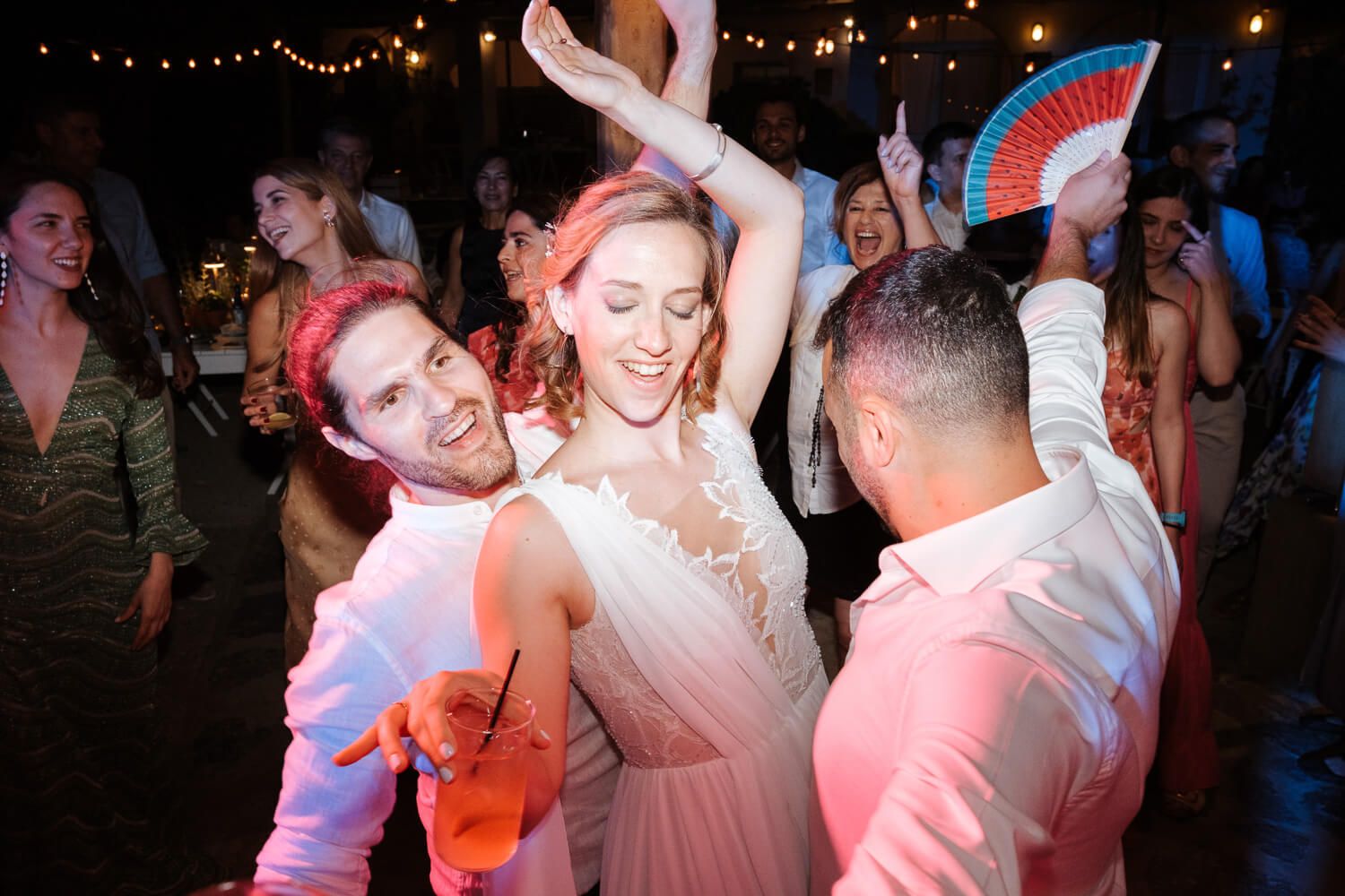 Bride Ioanna dancing enthusiastically with her friends