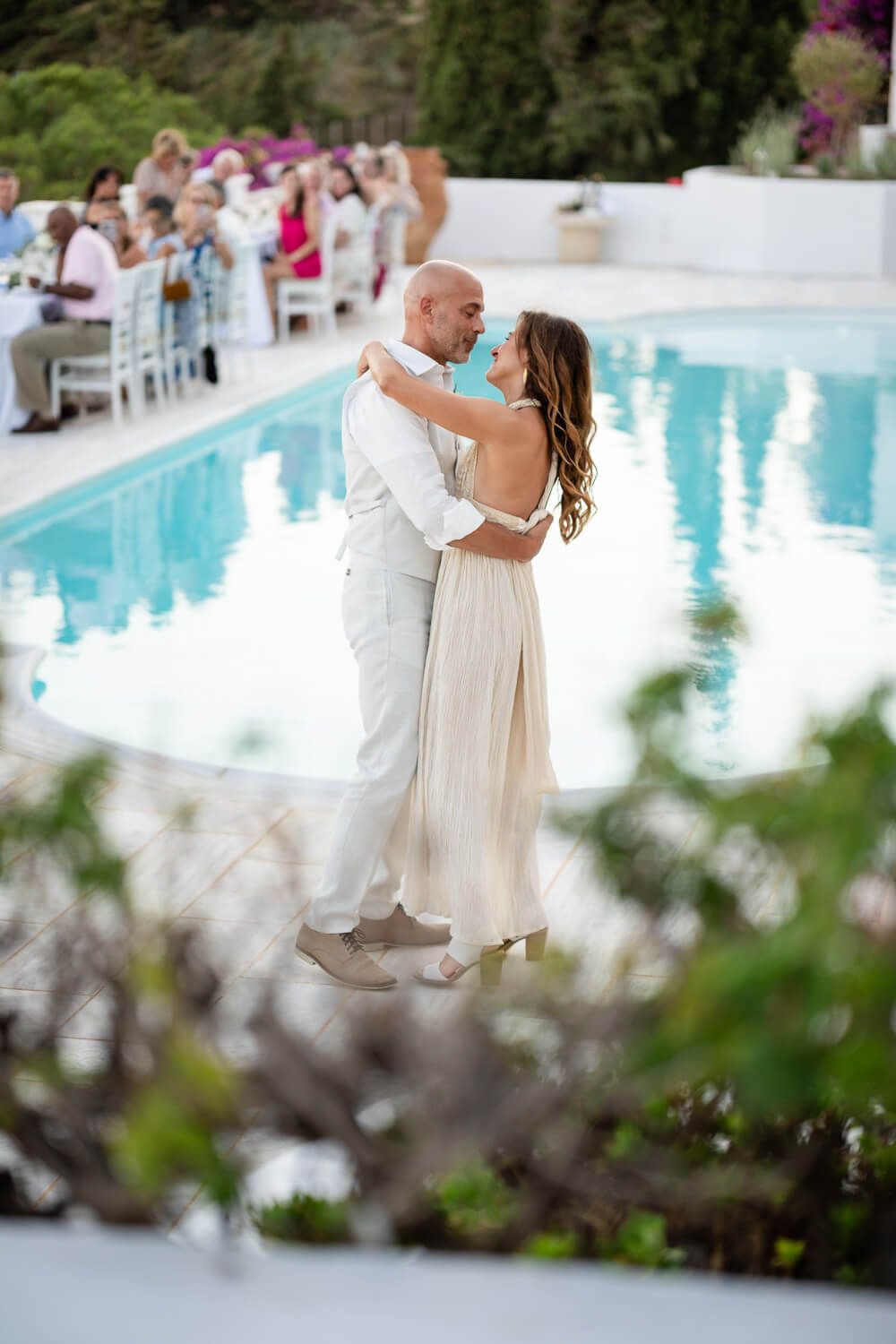 The couple sharing a romantic first dance by the pool in Paros