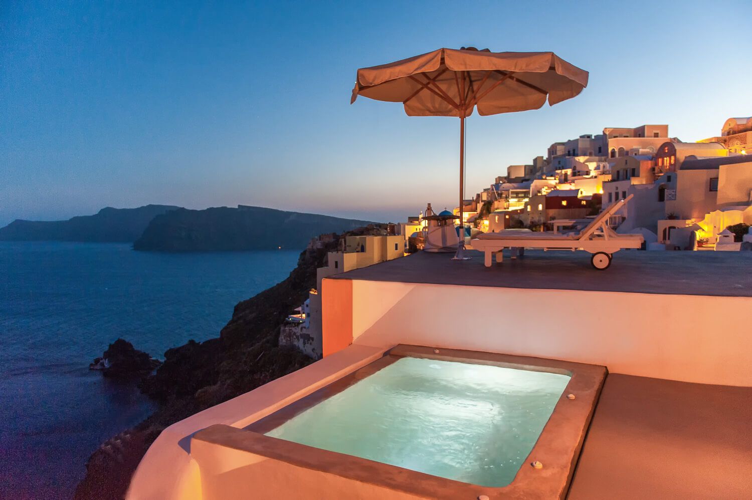 Santorini Chroma Suites exterior hot tub with a stunning caldera backdrop at sunset