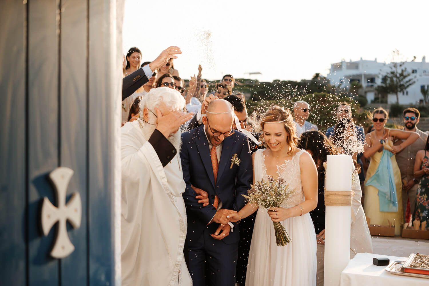 Joyful shower of rice as the newlyweds exit Pyrgaki chapel