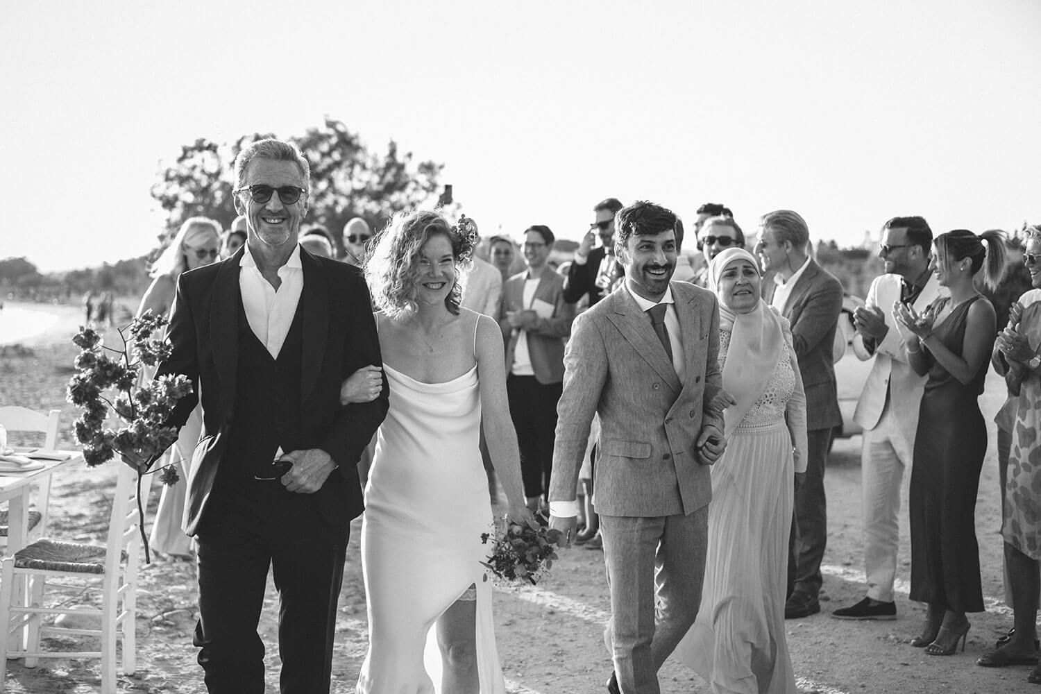 Bride Vanessa walking down the sandy aisle for her beachfront wedding