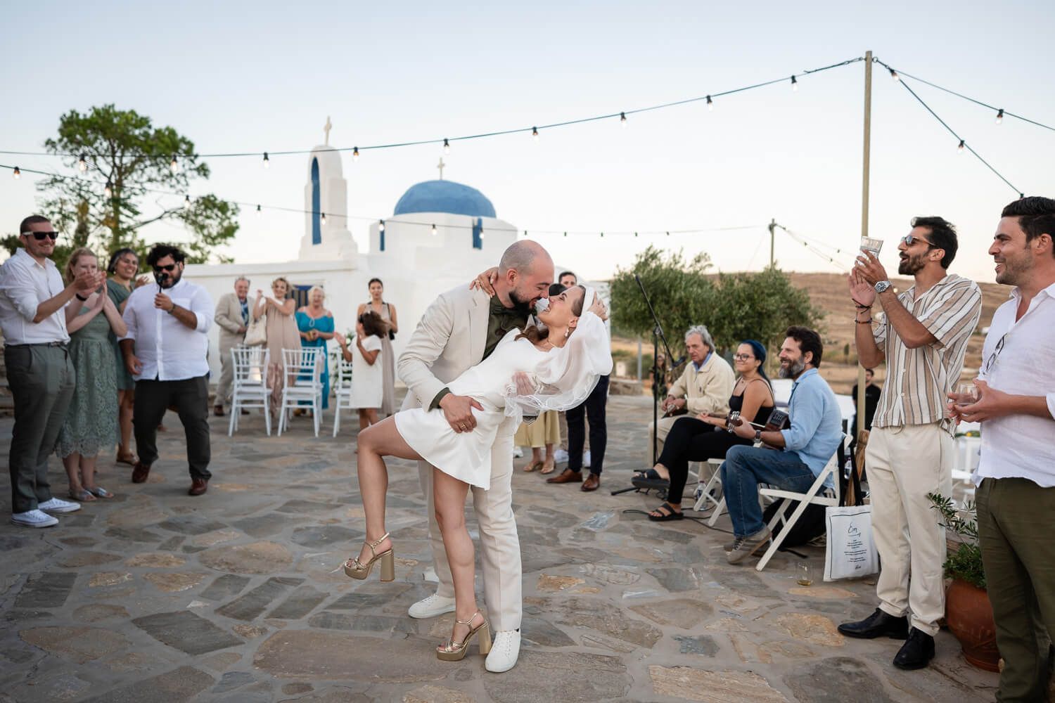 Marinos and Lisa sharing their first kiss as husband and wife in Paros