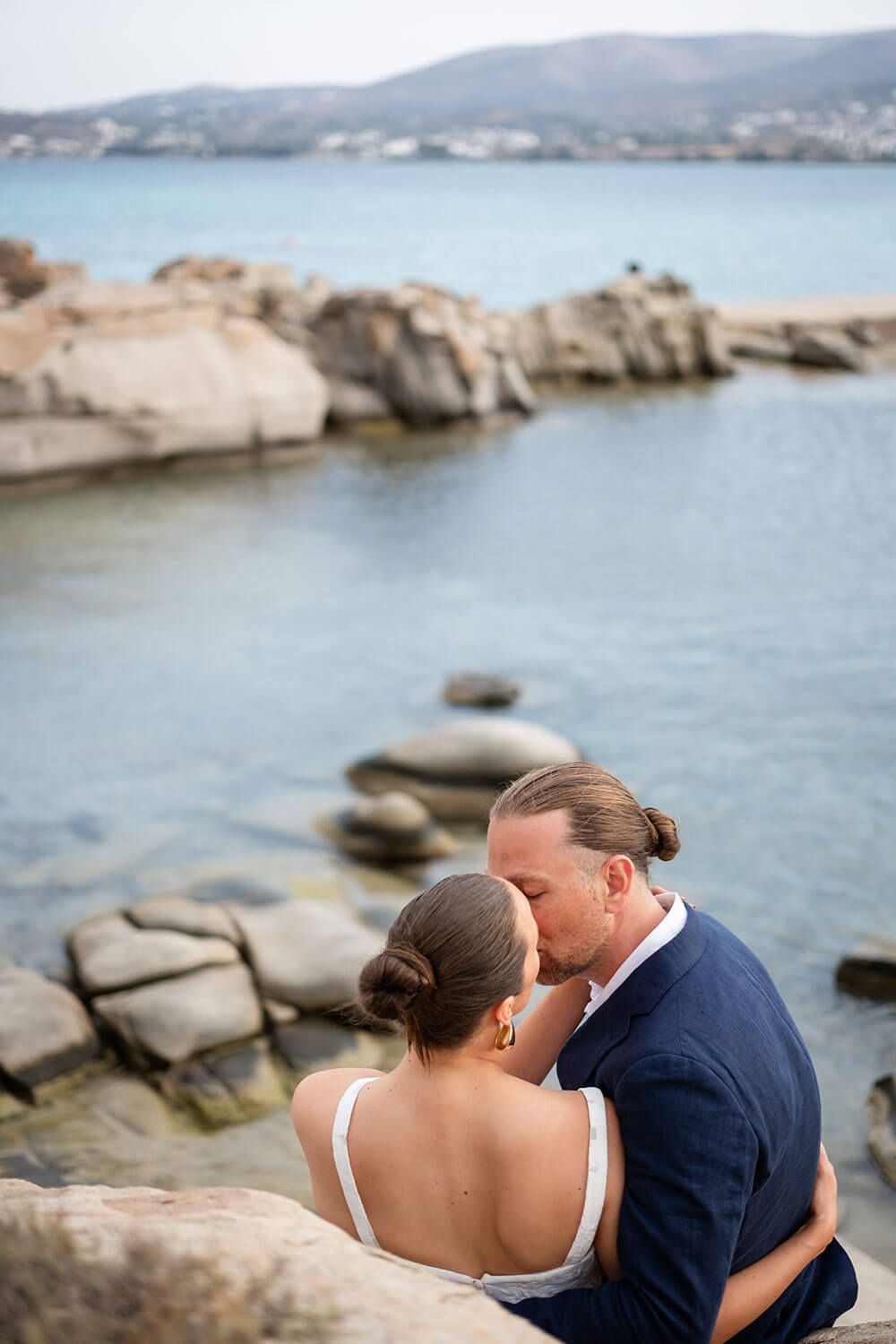 Romantic couple portrait with the unique Kolimbithres rock formations in Paros