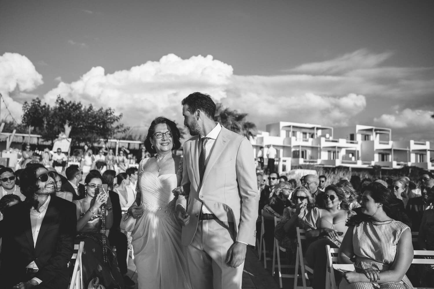 groom escorted by his mother during a symbolic ceremony at Seesoo Paros Hotel
