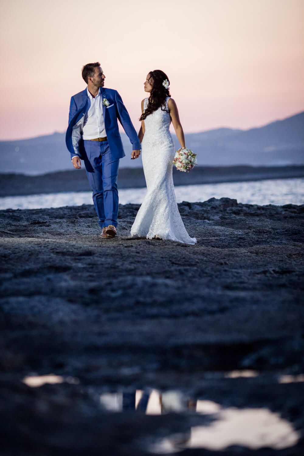 Cinematic wedding photo of bride and groom in Milos landscape