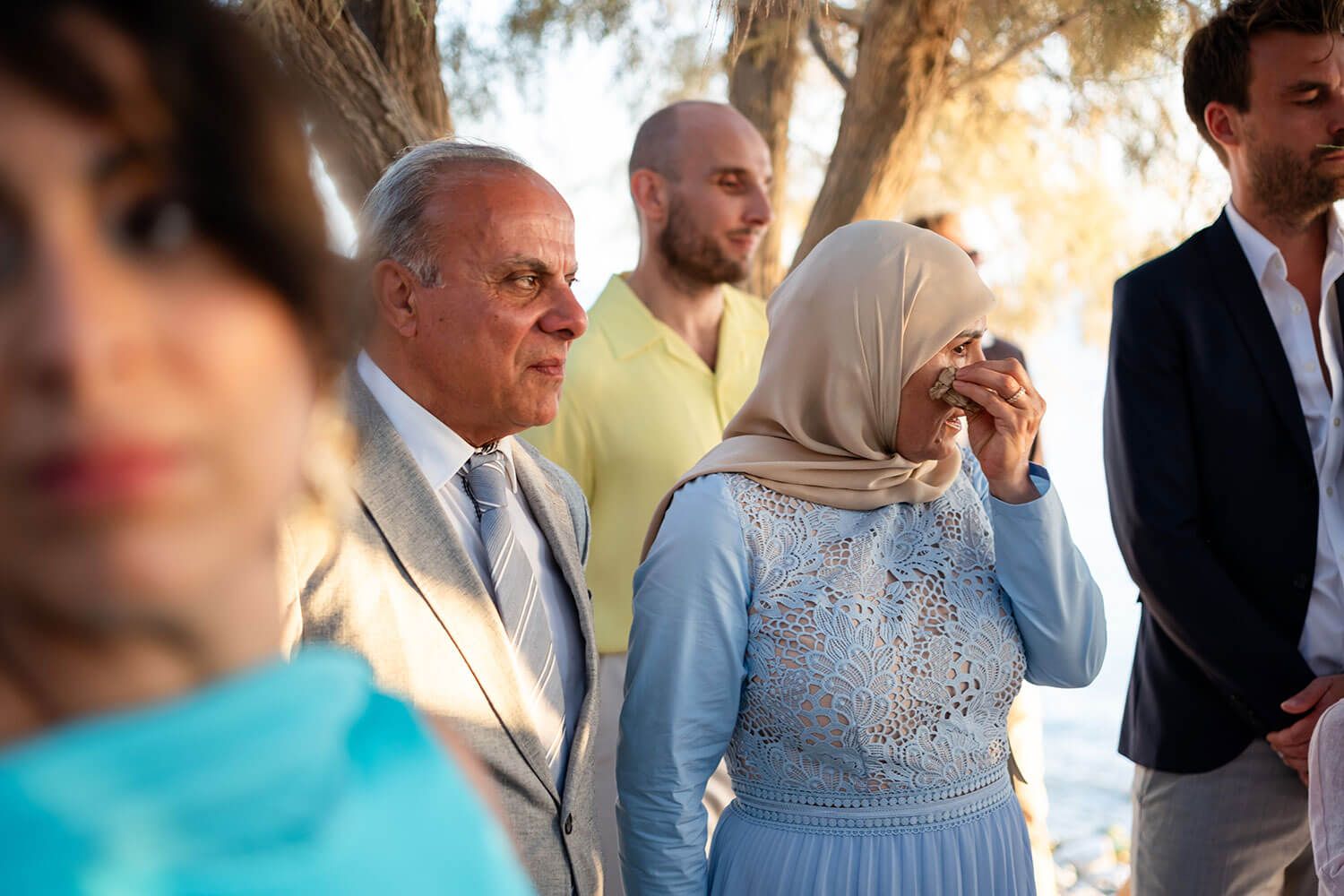 Candid moment of guests during a wedding by the Aegean Sea