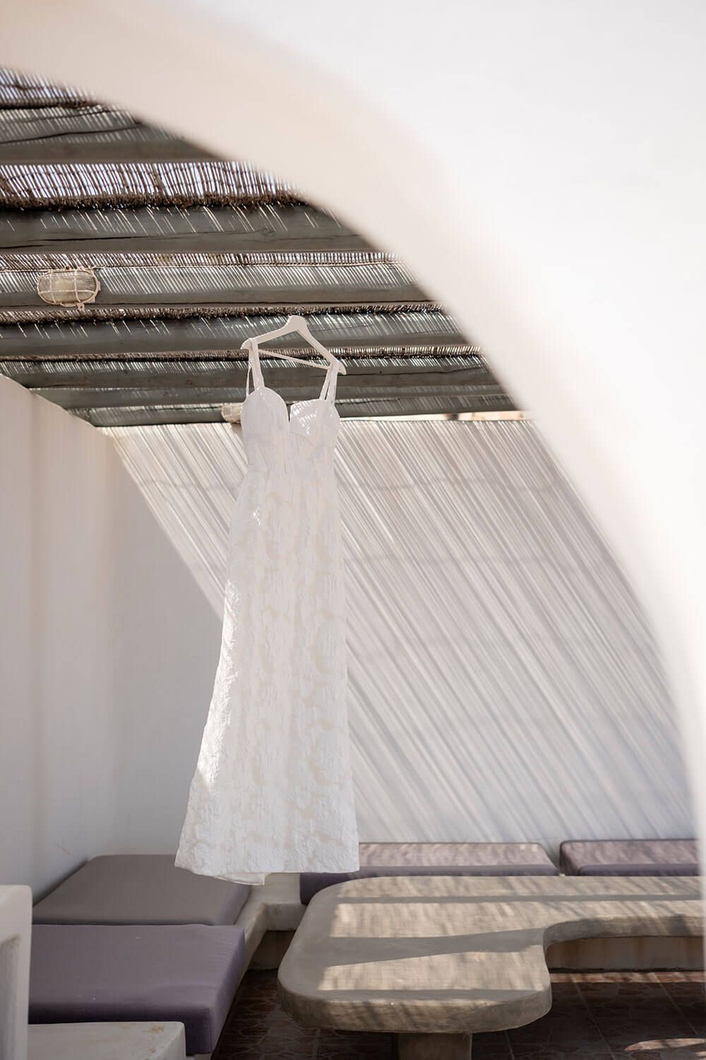 Wedding dress hanging in a beautiful Paros villa overlooking the Aegean Sea