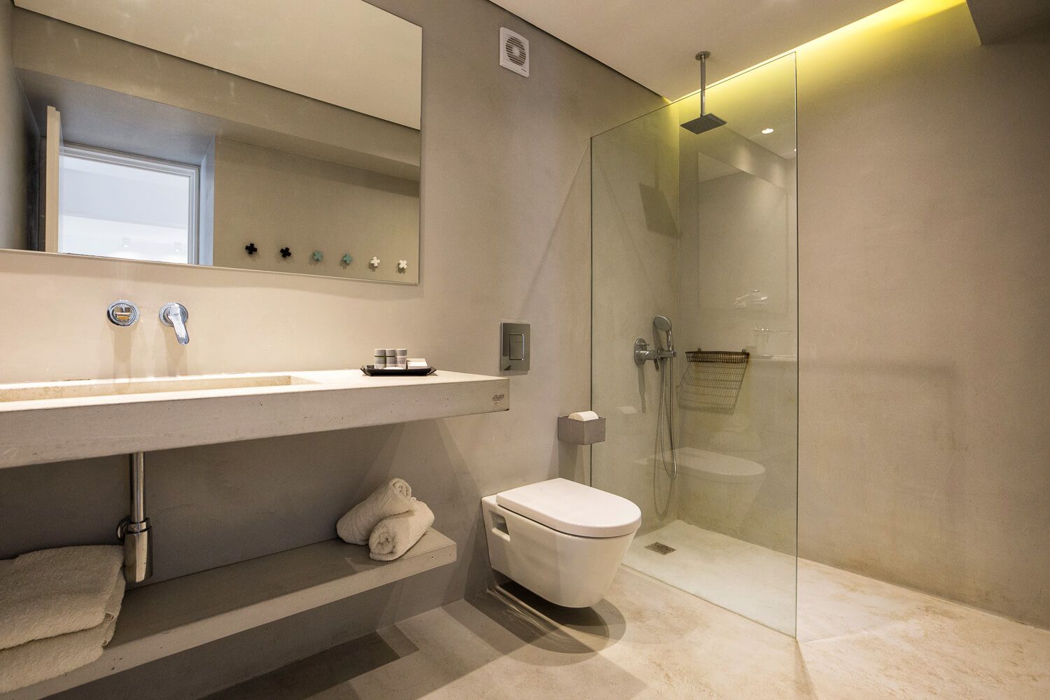Minimalist bathroom textures blending stone and modern glass