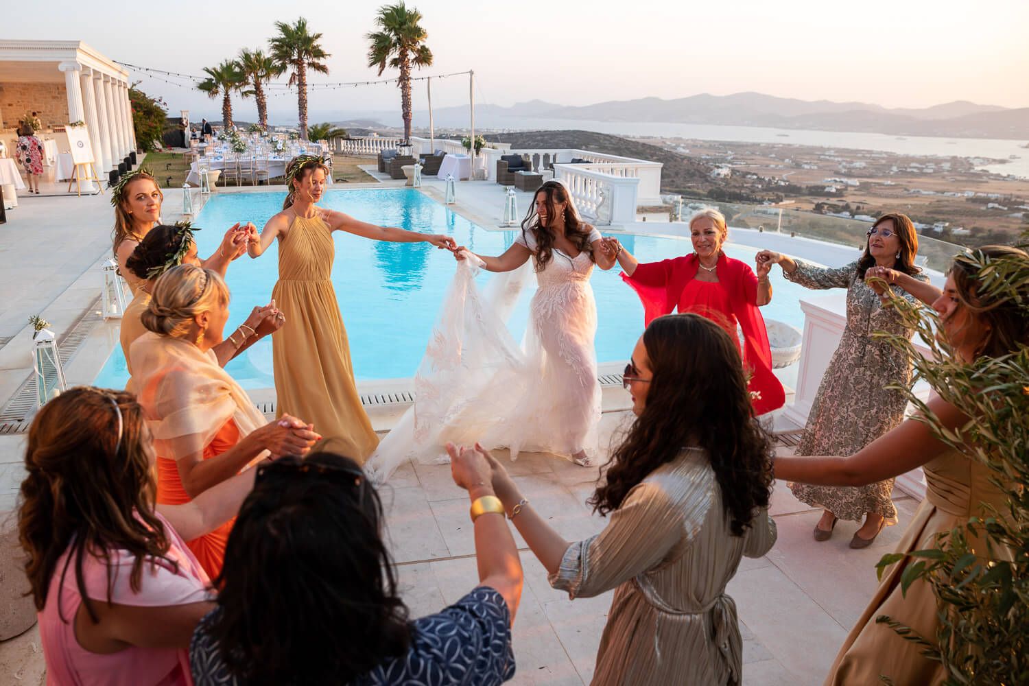 Guests dancing in circles after jewish wedding ceremony in Paros