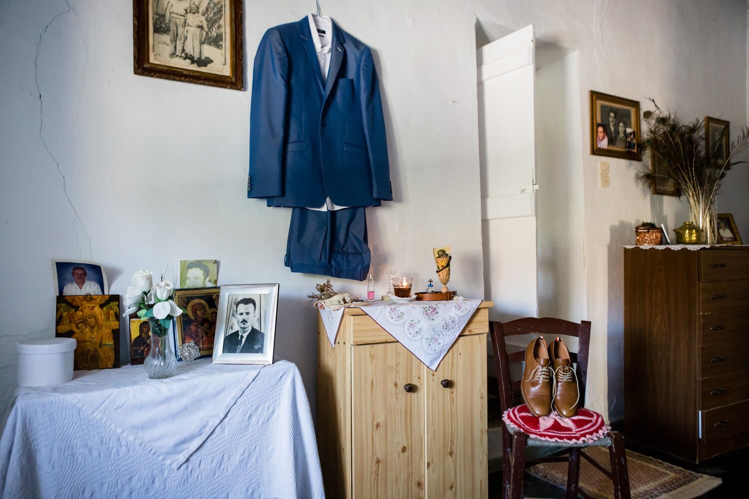 Groom getting ready at his grandmother's traditional house in Pachena Milos