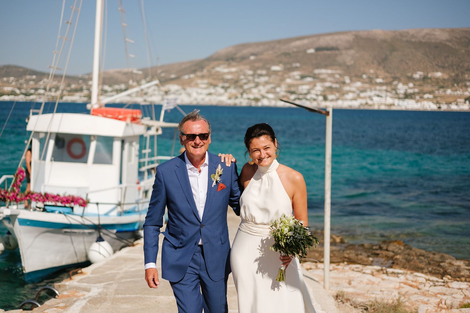 Bride arriving by boat at Agios Fokas chapel Paros