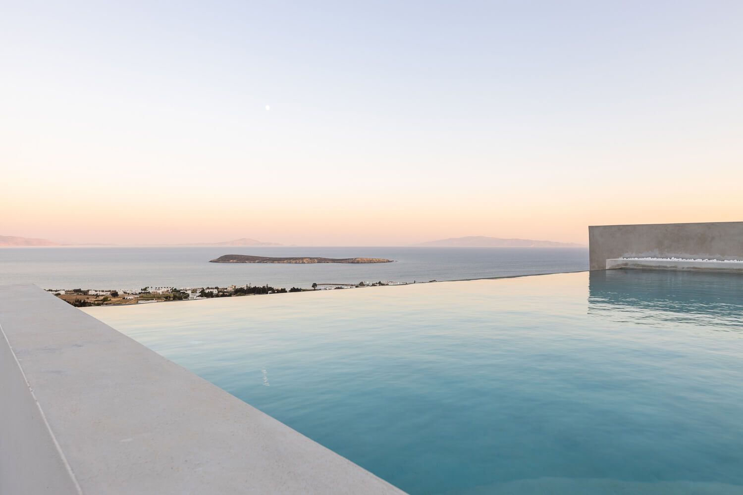 Luxury pool area  with a magnificent view to Naxos island at dusk