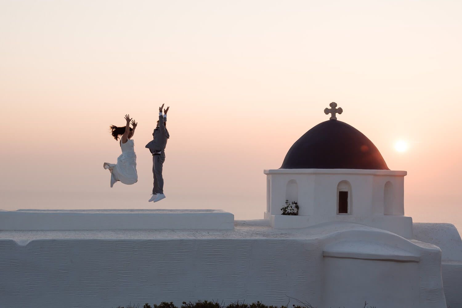 White Cycladic chapel on a hill at golden hour