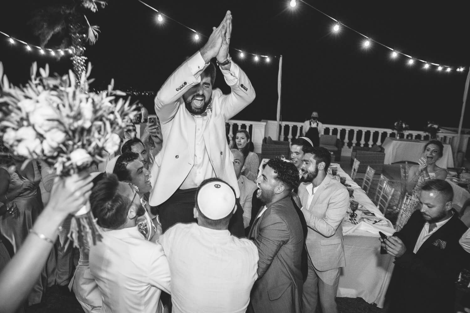 High energy Hora dance at Jewish wedding reception in Paros