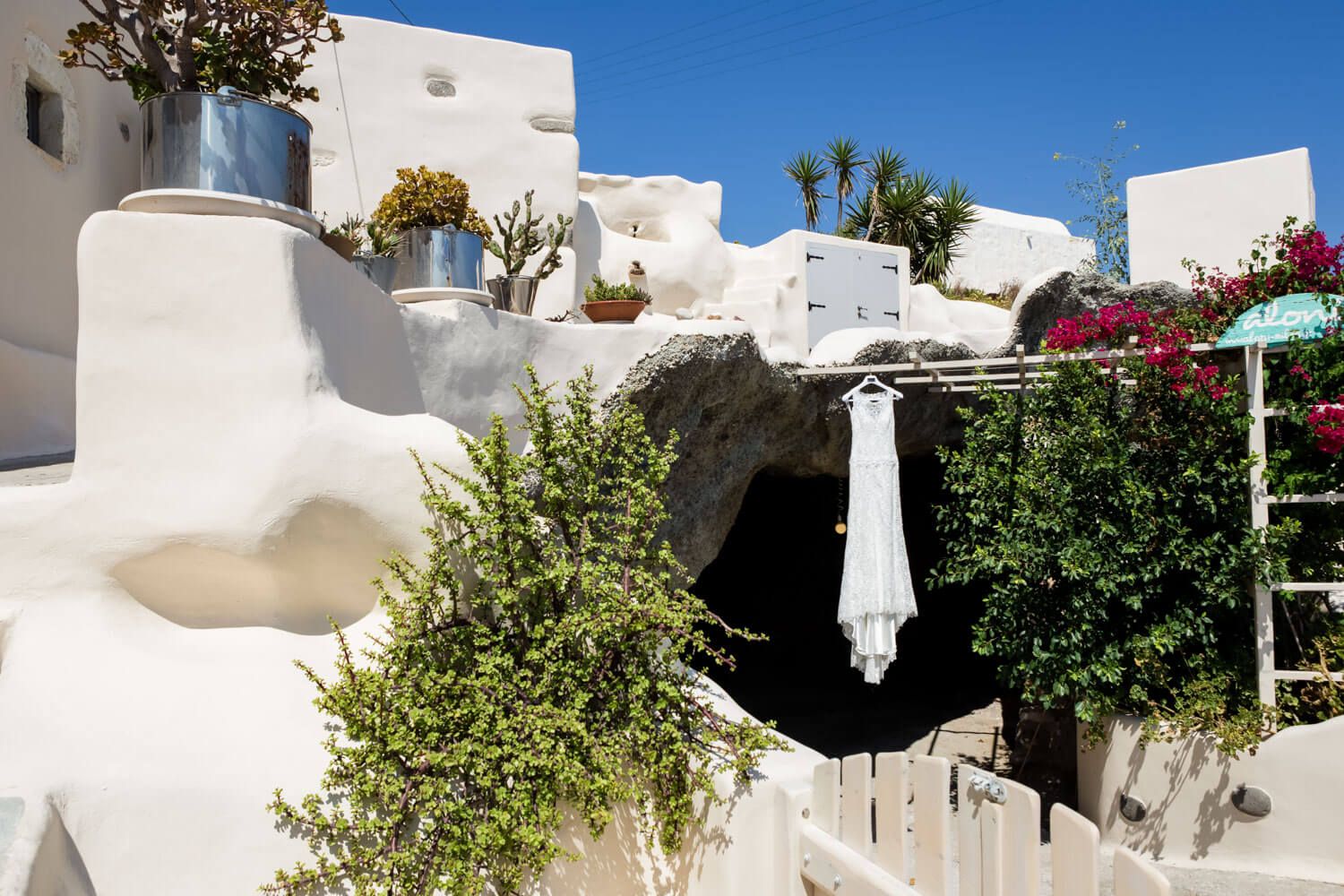 Wedding dress hanging on the stone wall of a cave house