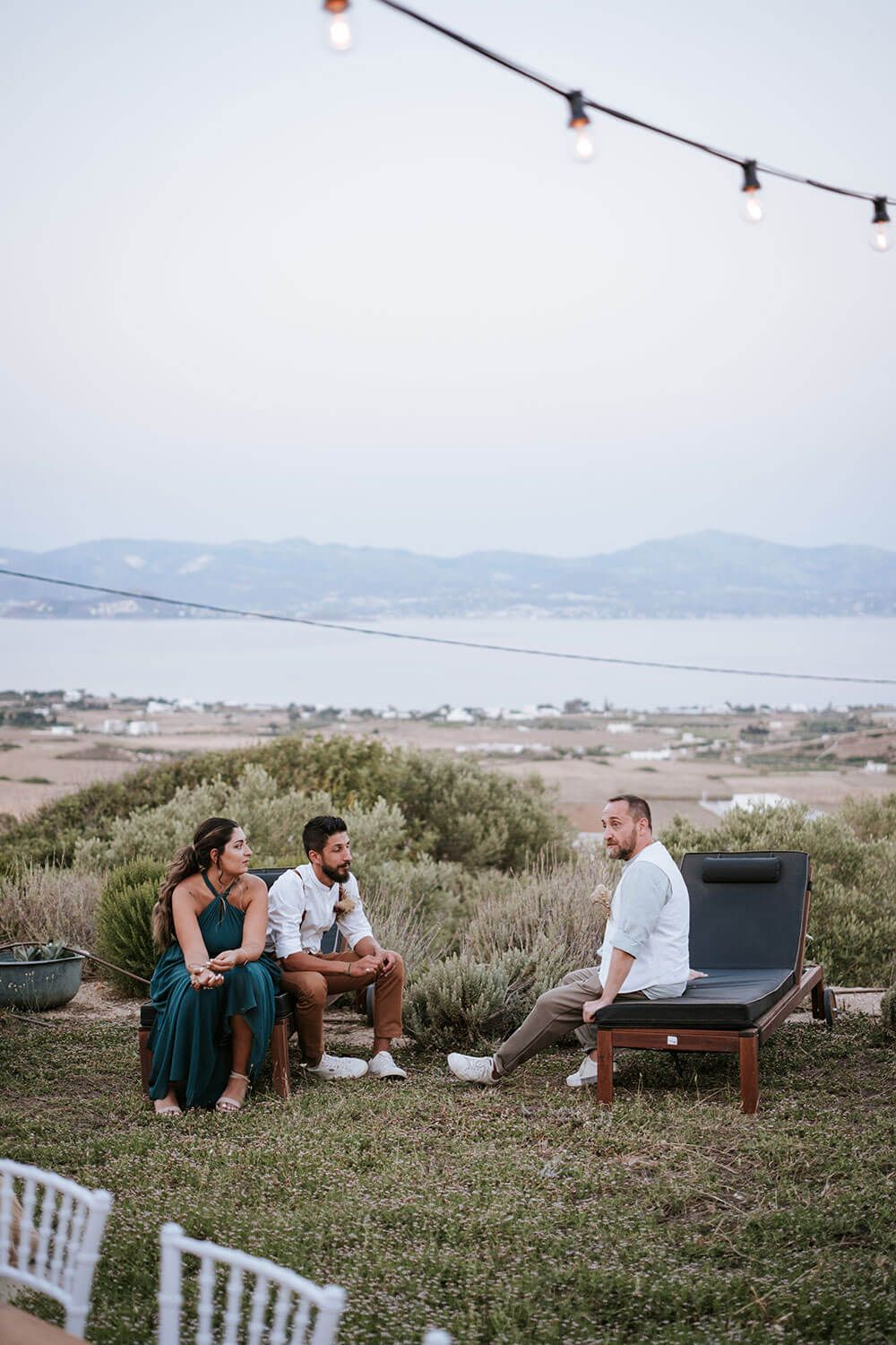 Wedding guests sitting and chatting during a weedding reception in Paros Greece
