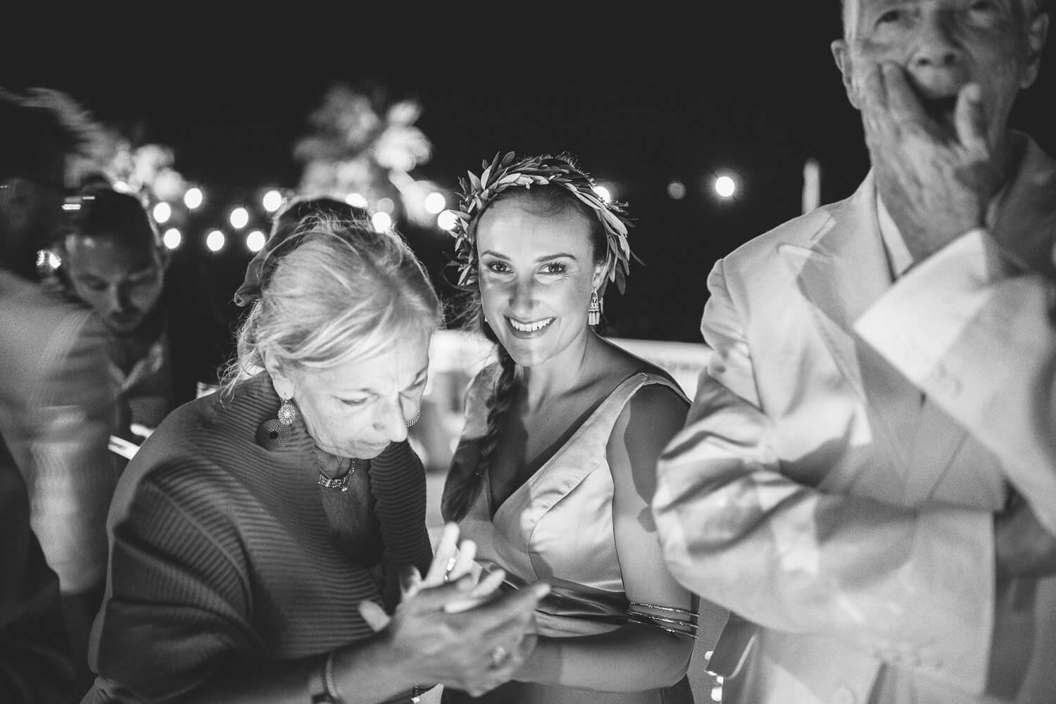 guests at Jewish wedding party at night under the stars in Villa Aethra