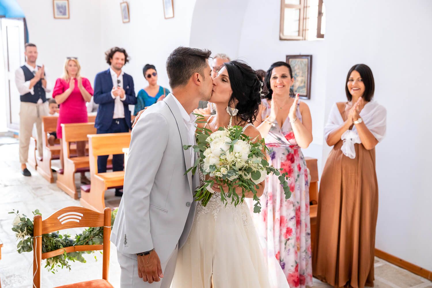 The couple sharing their first kiss as husband and wife in Paros