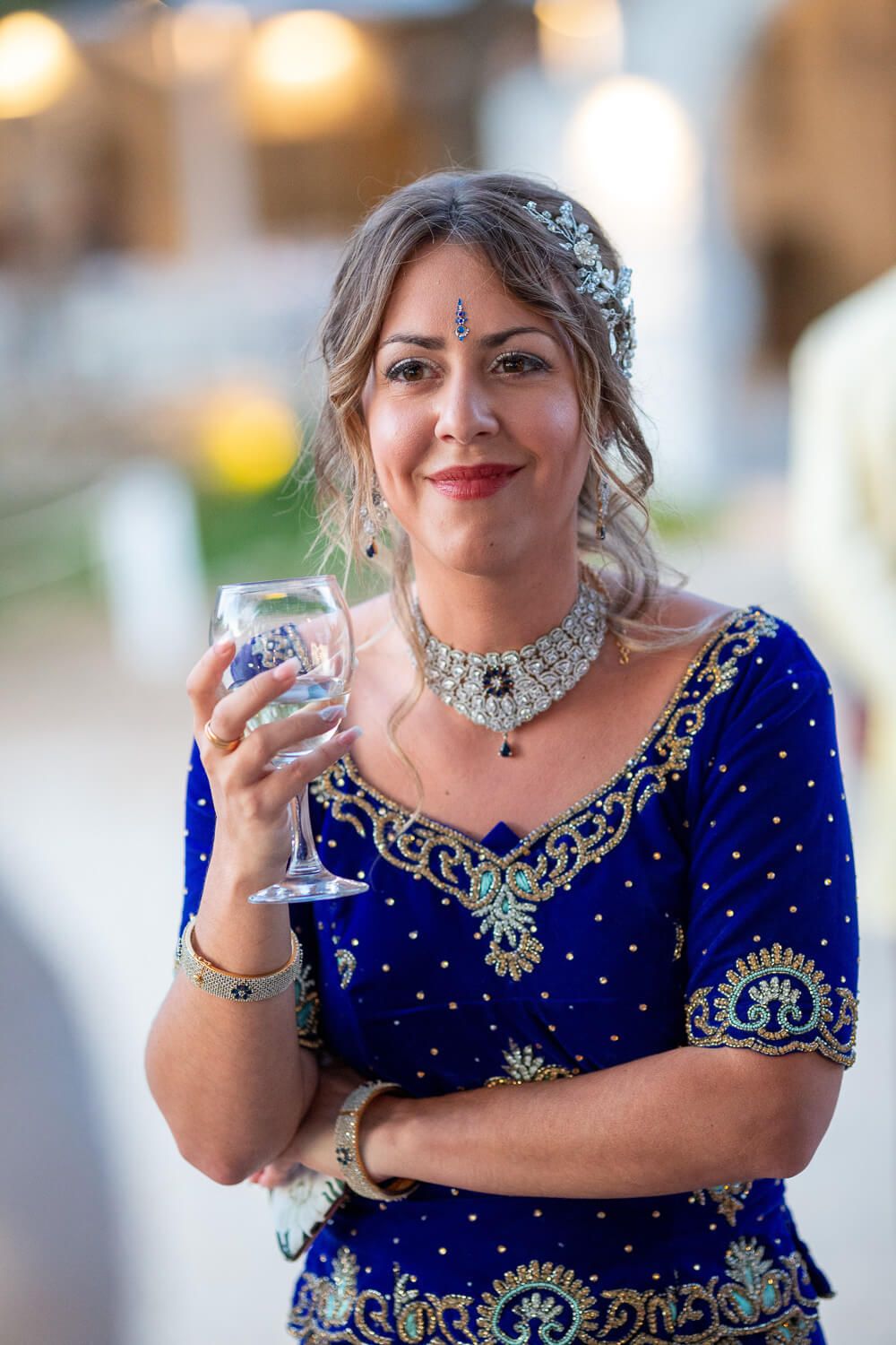 Bride enjoying a drink outside Thalassamou restaurant before the wedding dinner