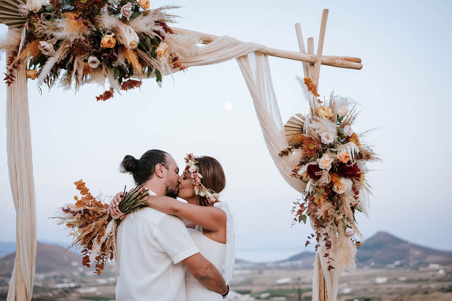 Newlyweds sharing their first kiss as husband and wife at sunset