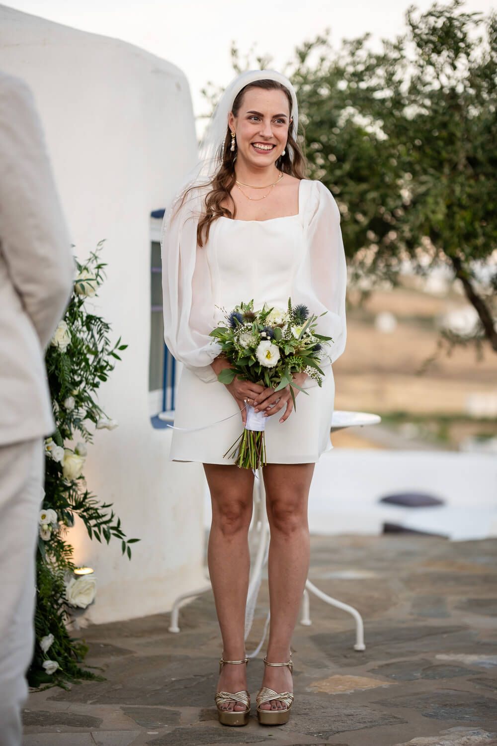 Beautiful bridal portrait of Lisa with the Cycladic landscape behind her