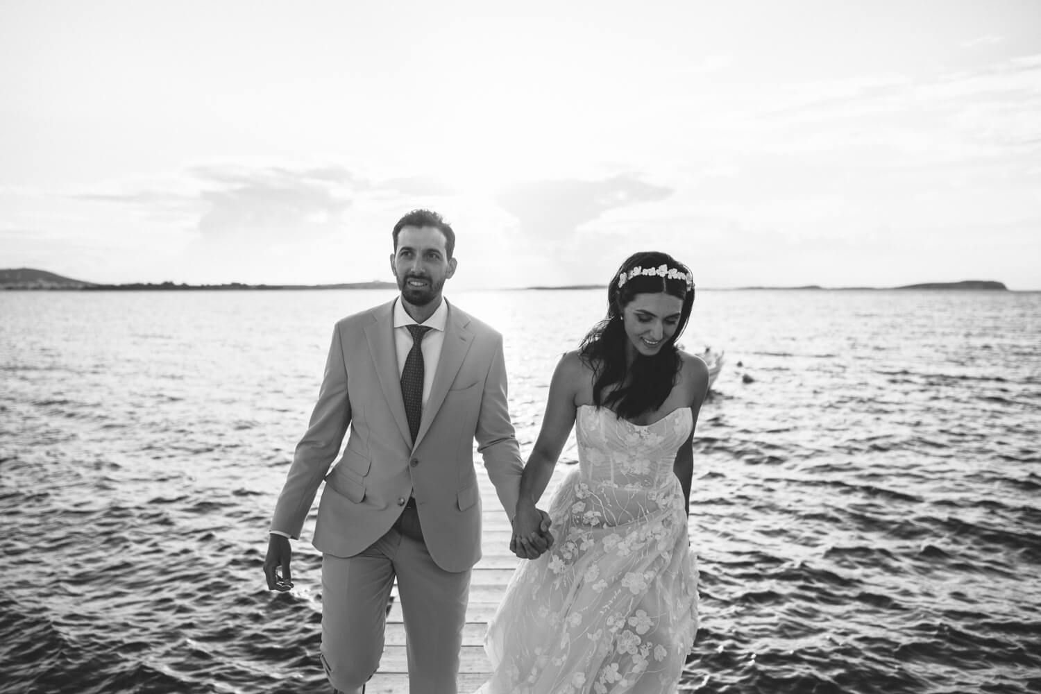 Stephanie and Khalil walking by the sea after their symbolic ceremony