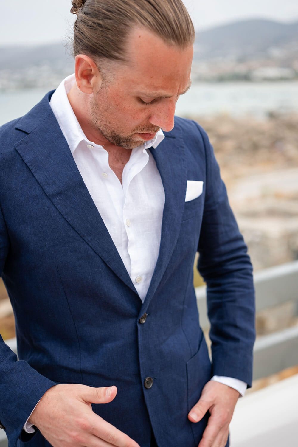 Groom adjusting his suit before his intimate wedding in Paros
