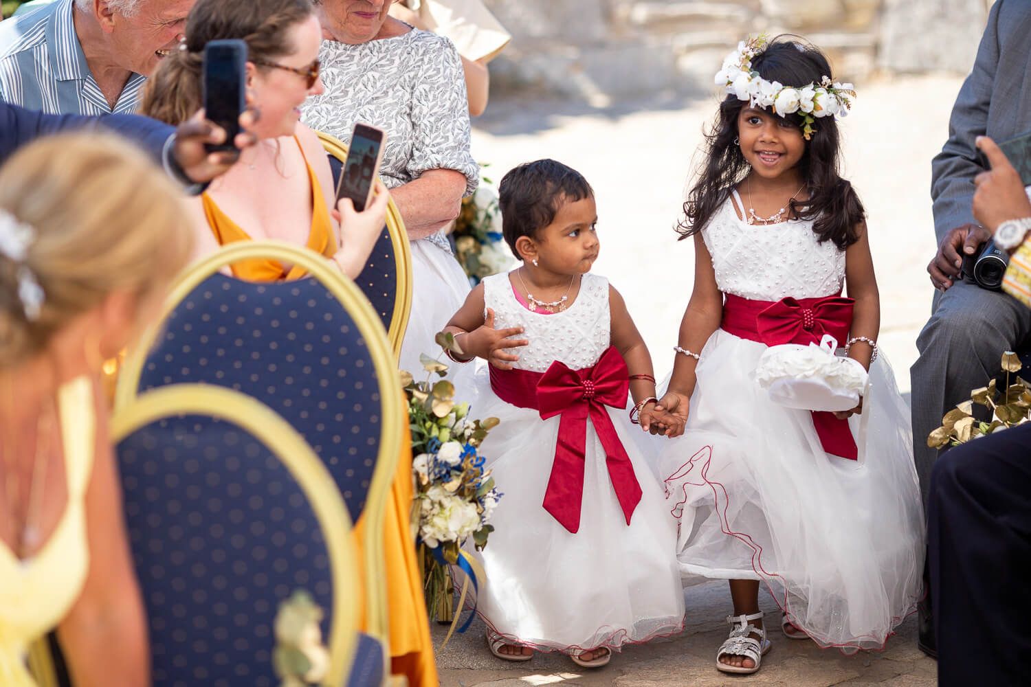 Guests throwing petals at the smiling couple after their symbolic ceremony