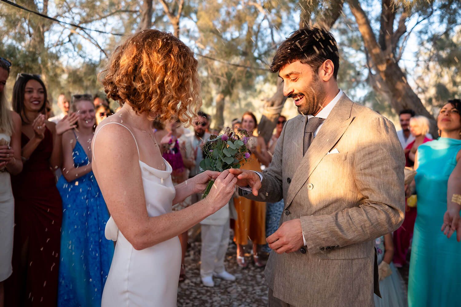 The couple exchanging rings with the sound of the waves in Paros