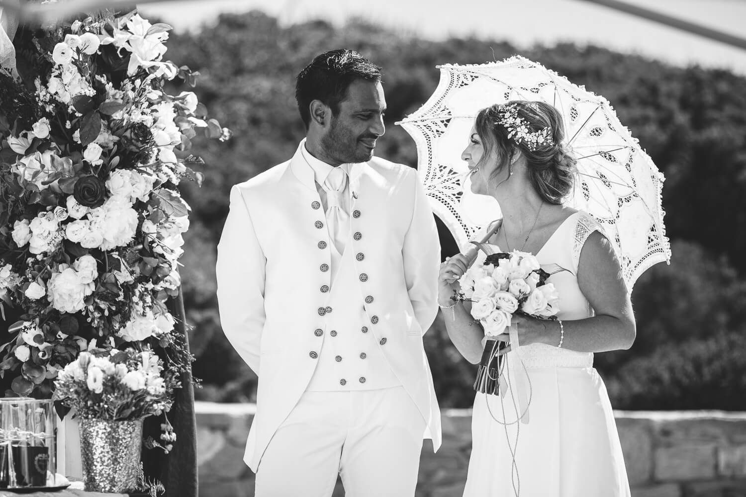 Couple looking at each other during their symbolic wedding ceremony at Pyrgaki Paros