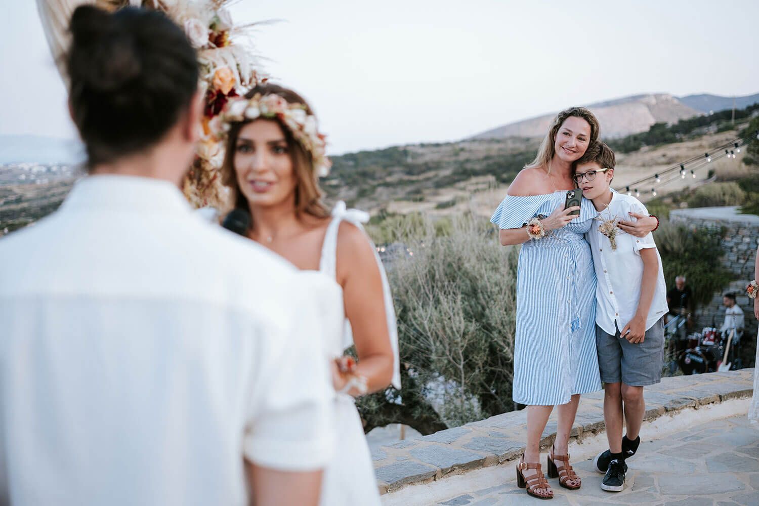 Couple exchanging vows with a magical sunset backdrop in the Cyclades