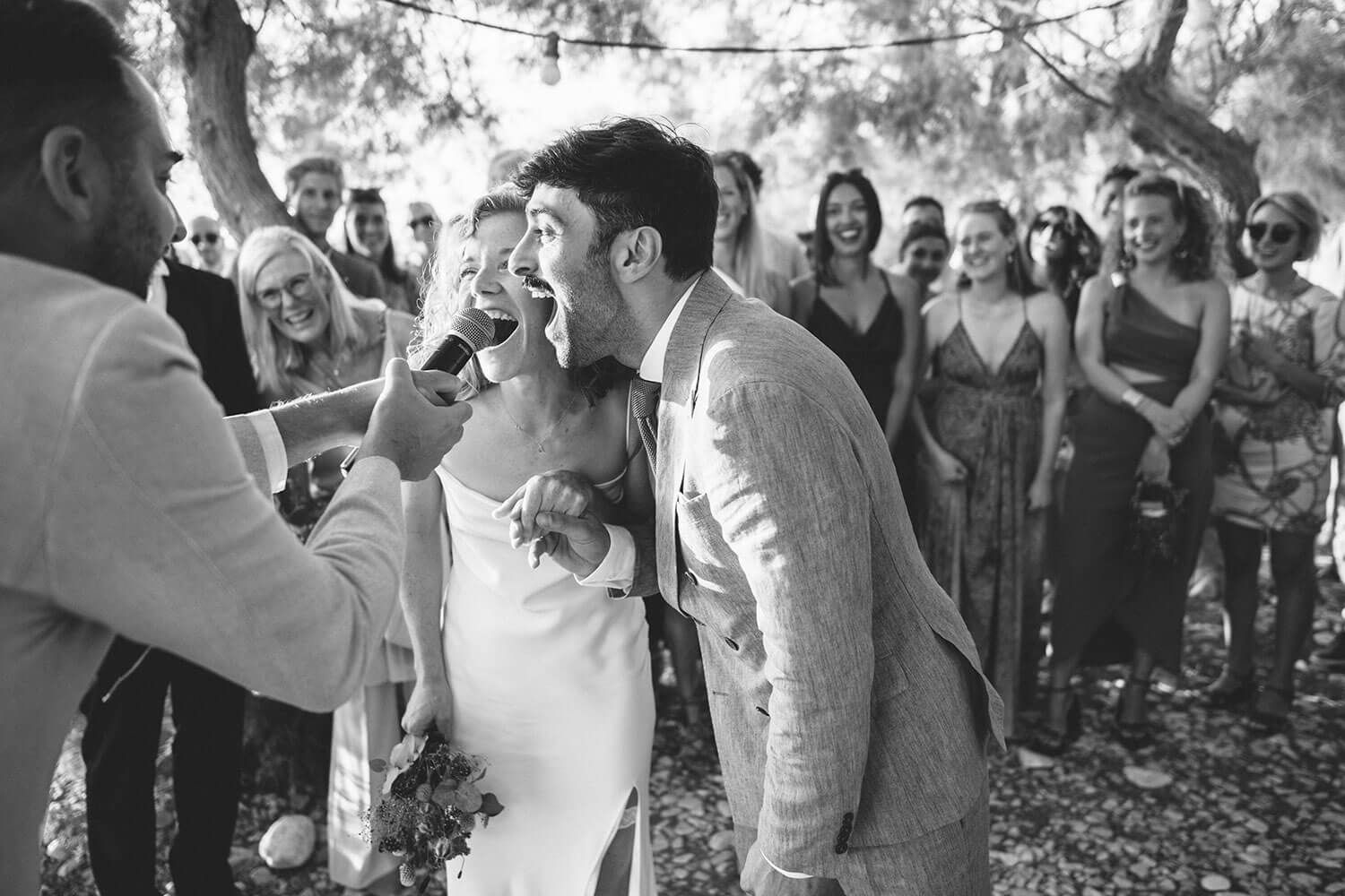 The couple exchanging vows with the sound of the waves in Paros