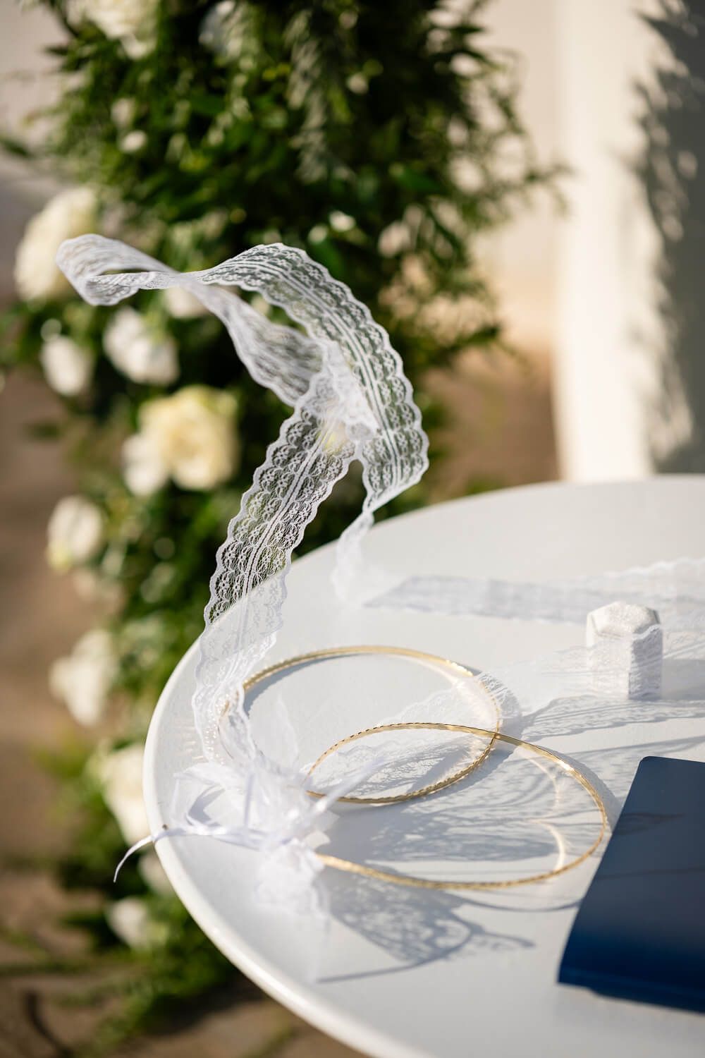 Close up of the traditional Greek wedding crowns (stefana) resting on a white table