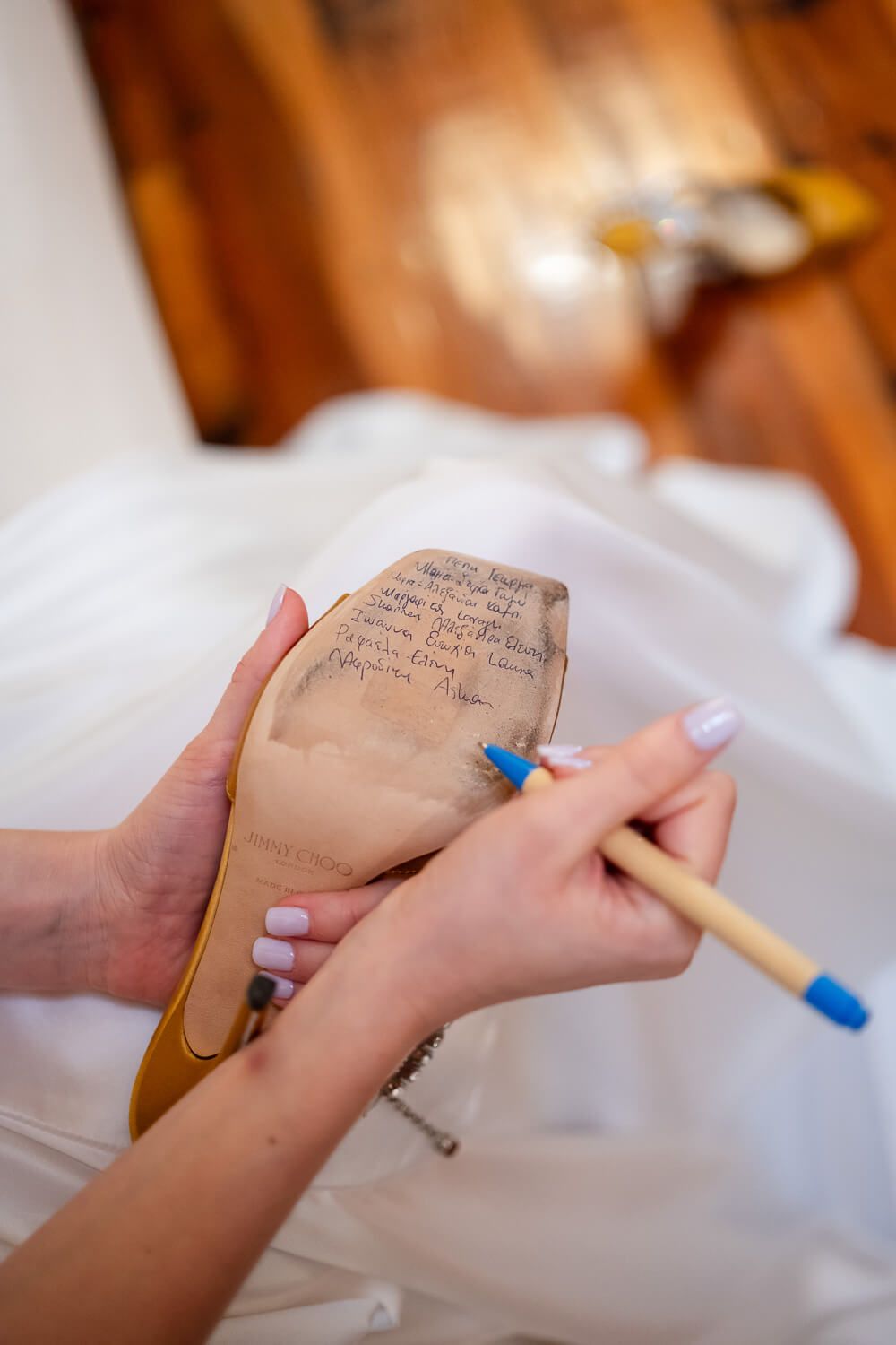 Bride writing on her shoes before her wedding in Syros