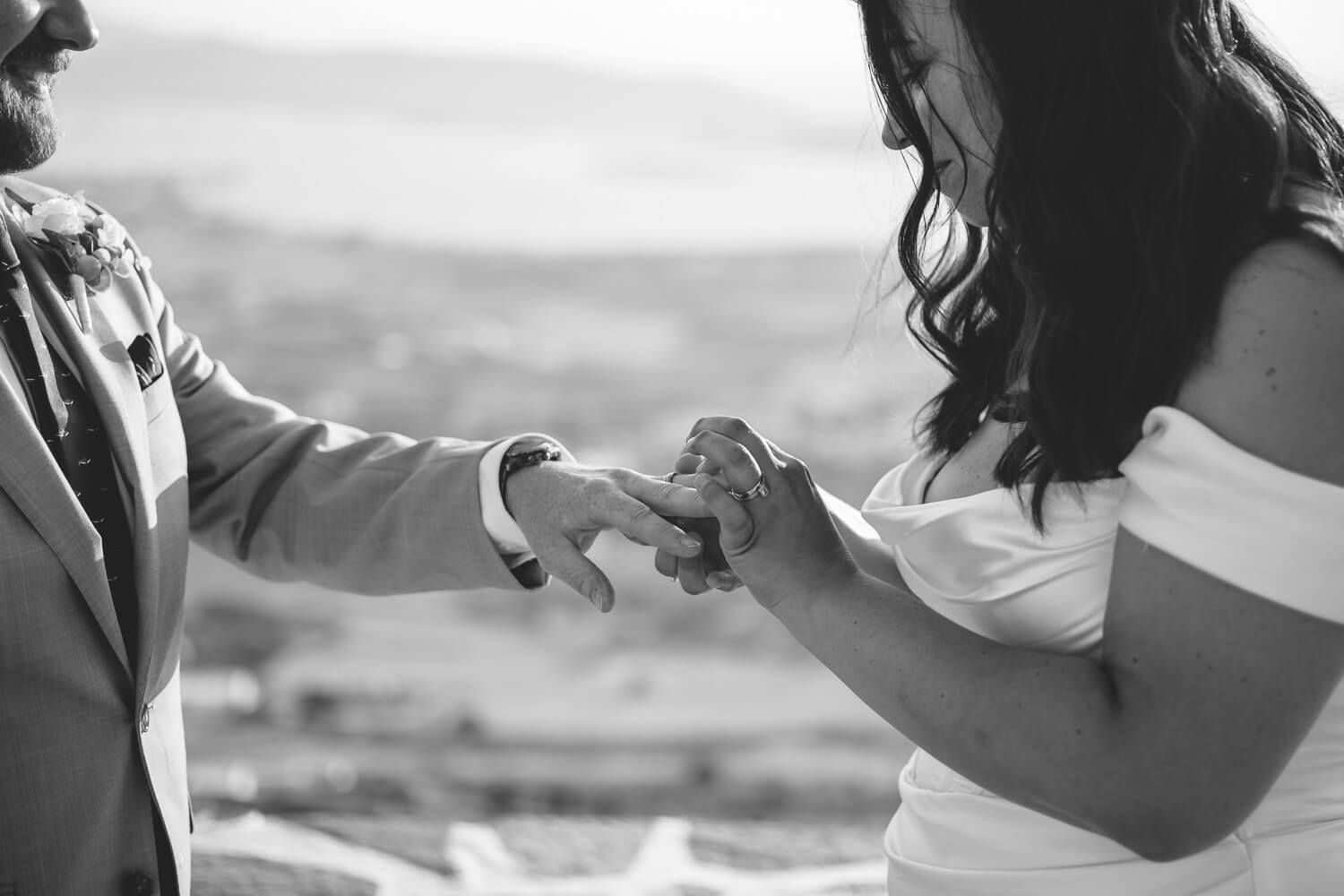 Exchange of wedding rings during hilltop ceremony in Paros