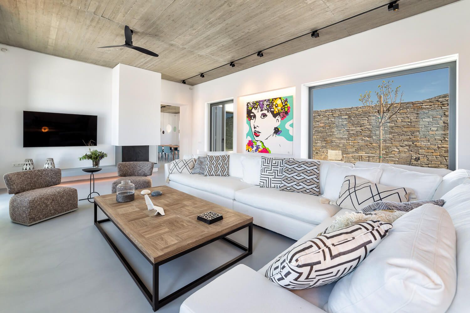 Modern living room with concrete ceiling at a villa in Paros.
