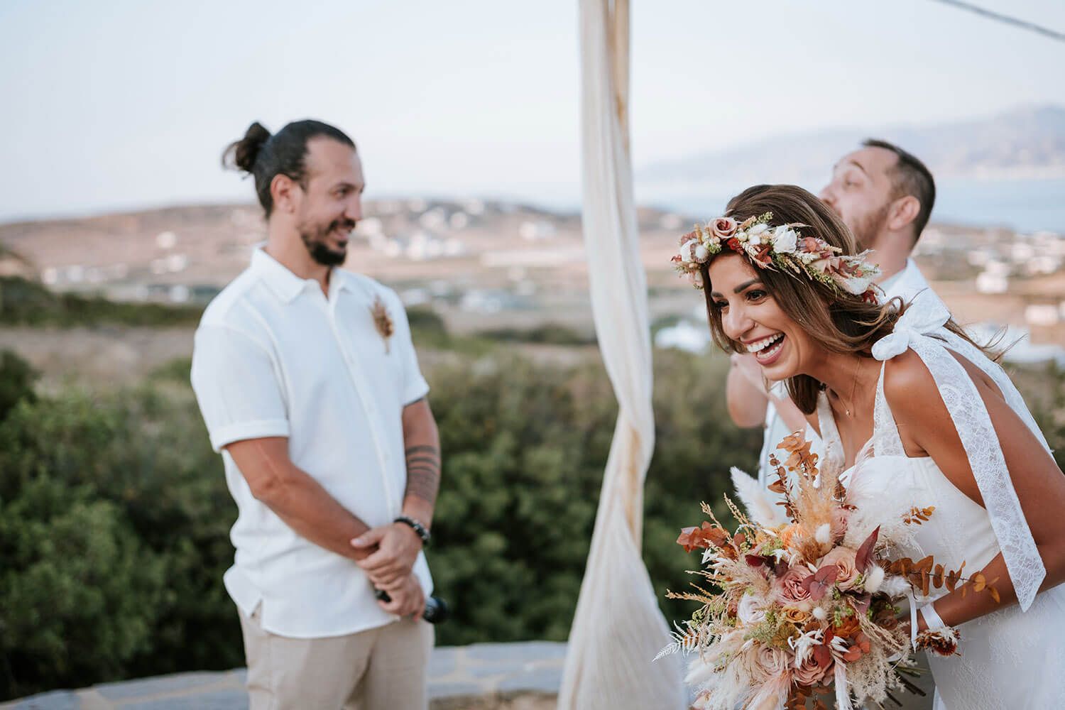 Guests smiling during a heartfelt boho wedding ceremony in Greece