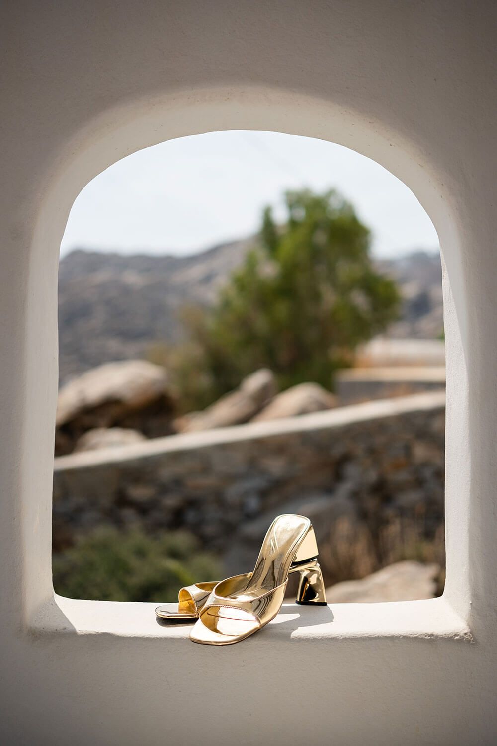 Bridal shoes and accessories laid out for an intimate wedding in Paros