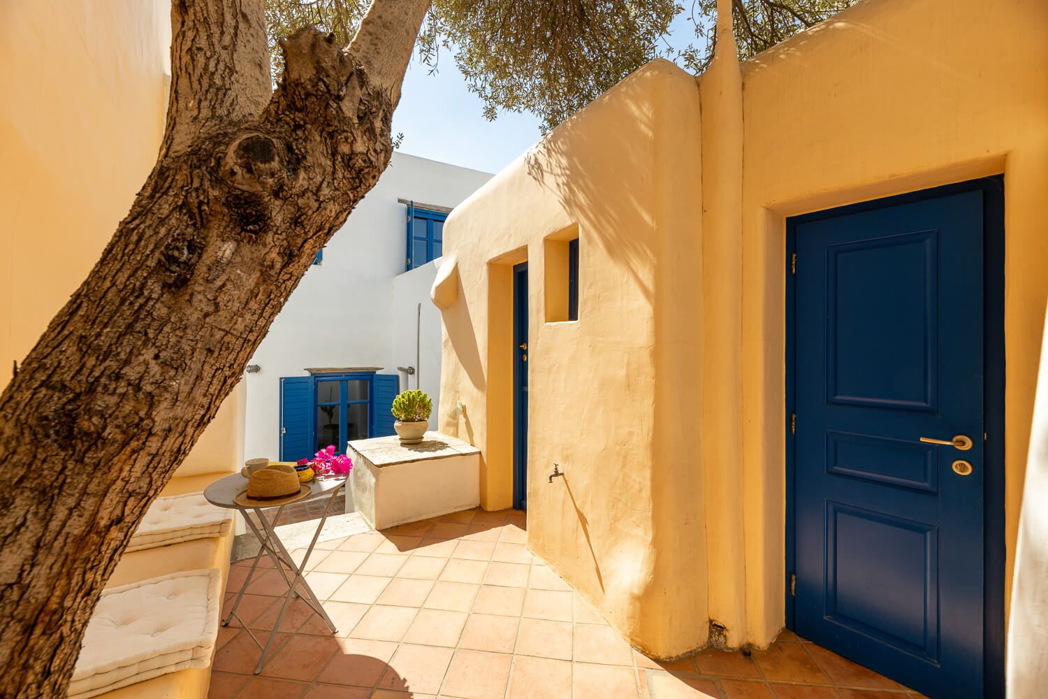 The serene exterior environment of a restored Greek settlement home