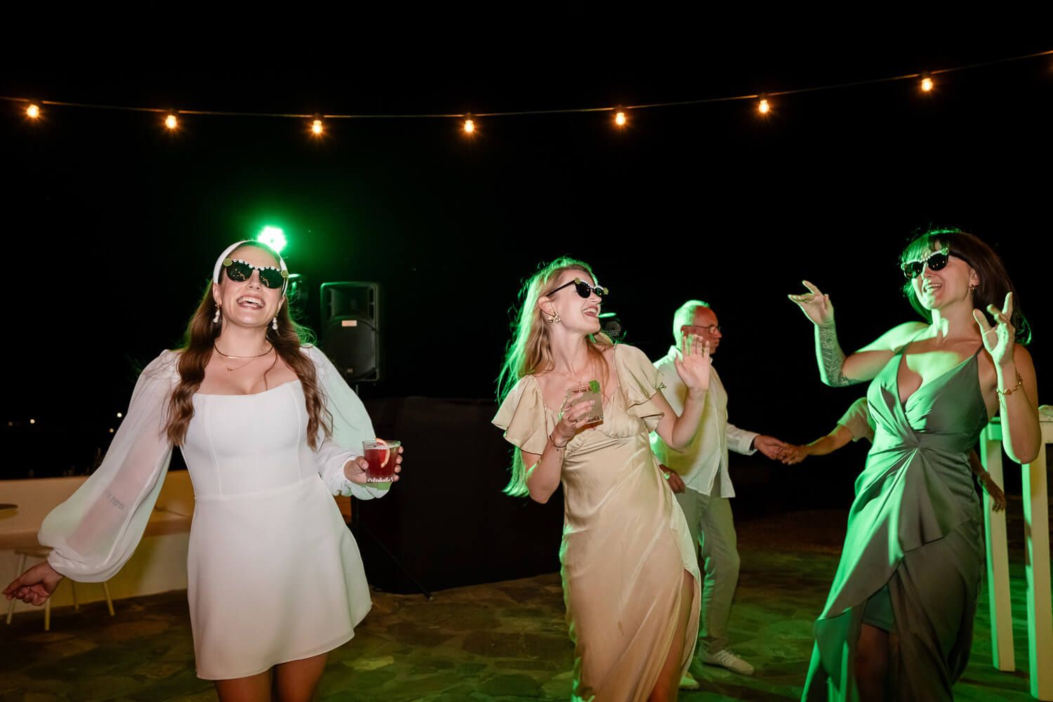 High-energy wedding party starting with traditional Greek island dancing