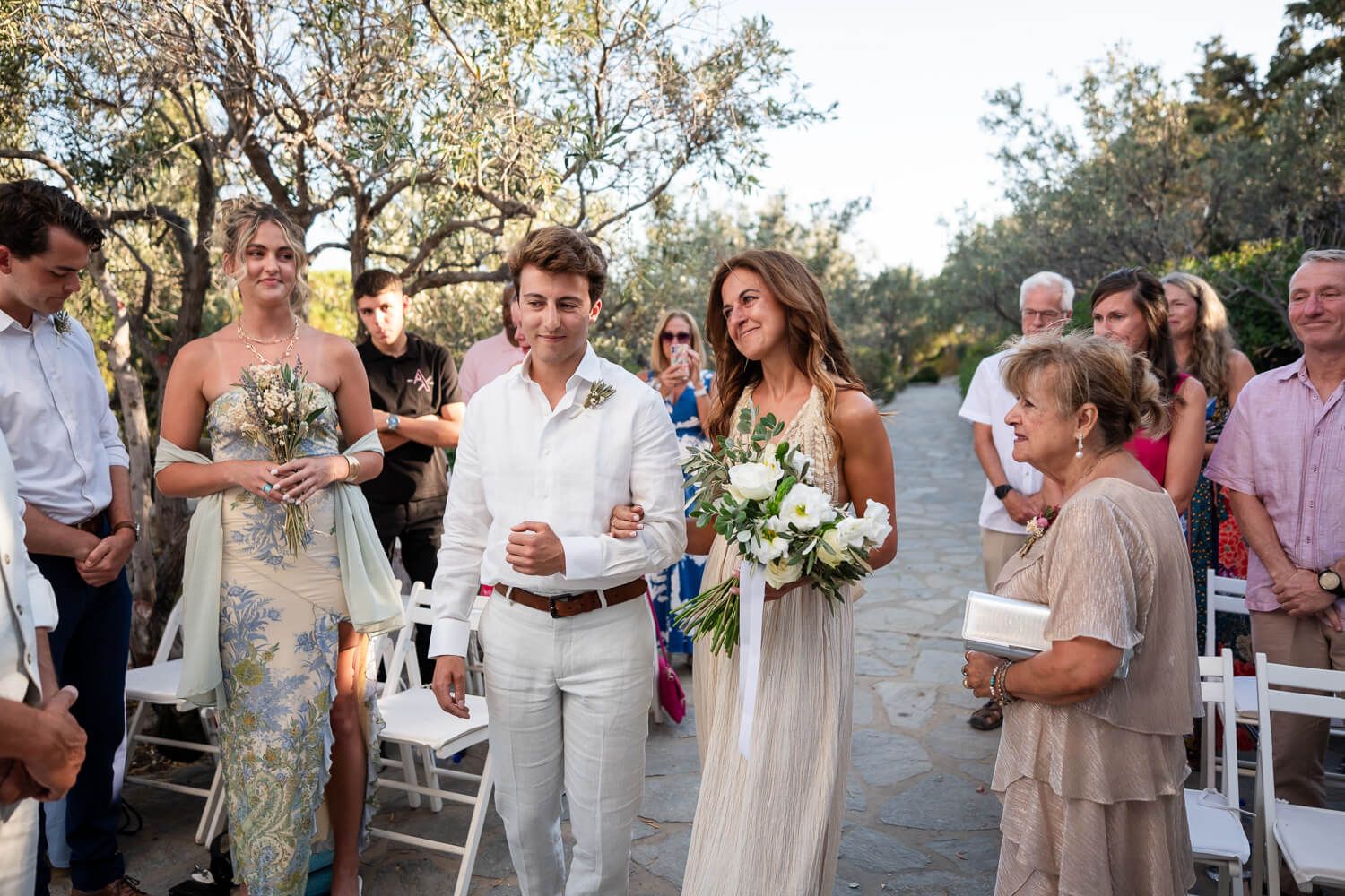 Bride Kathy walking down the aisle for her small Paros wedding