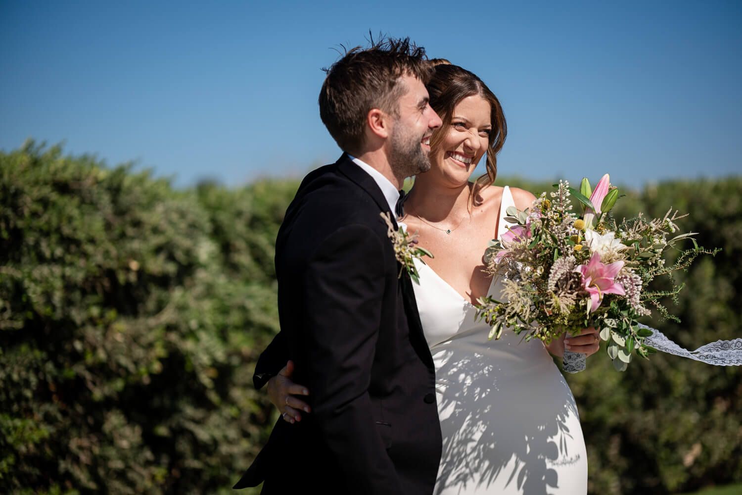 Jess and Daniel hugging in the courtyard of their Paros wedding villa