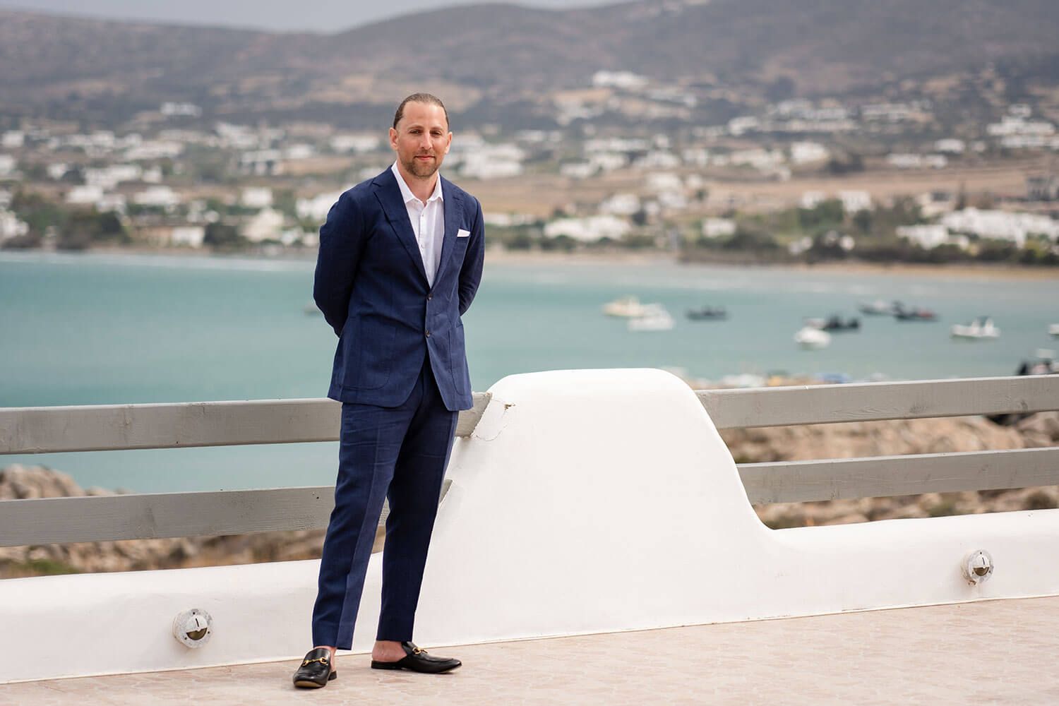 Groom waiting on the villa rooftop for his bride in Paros