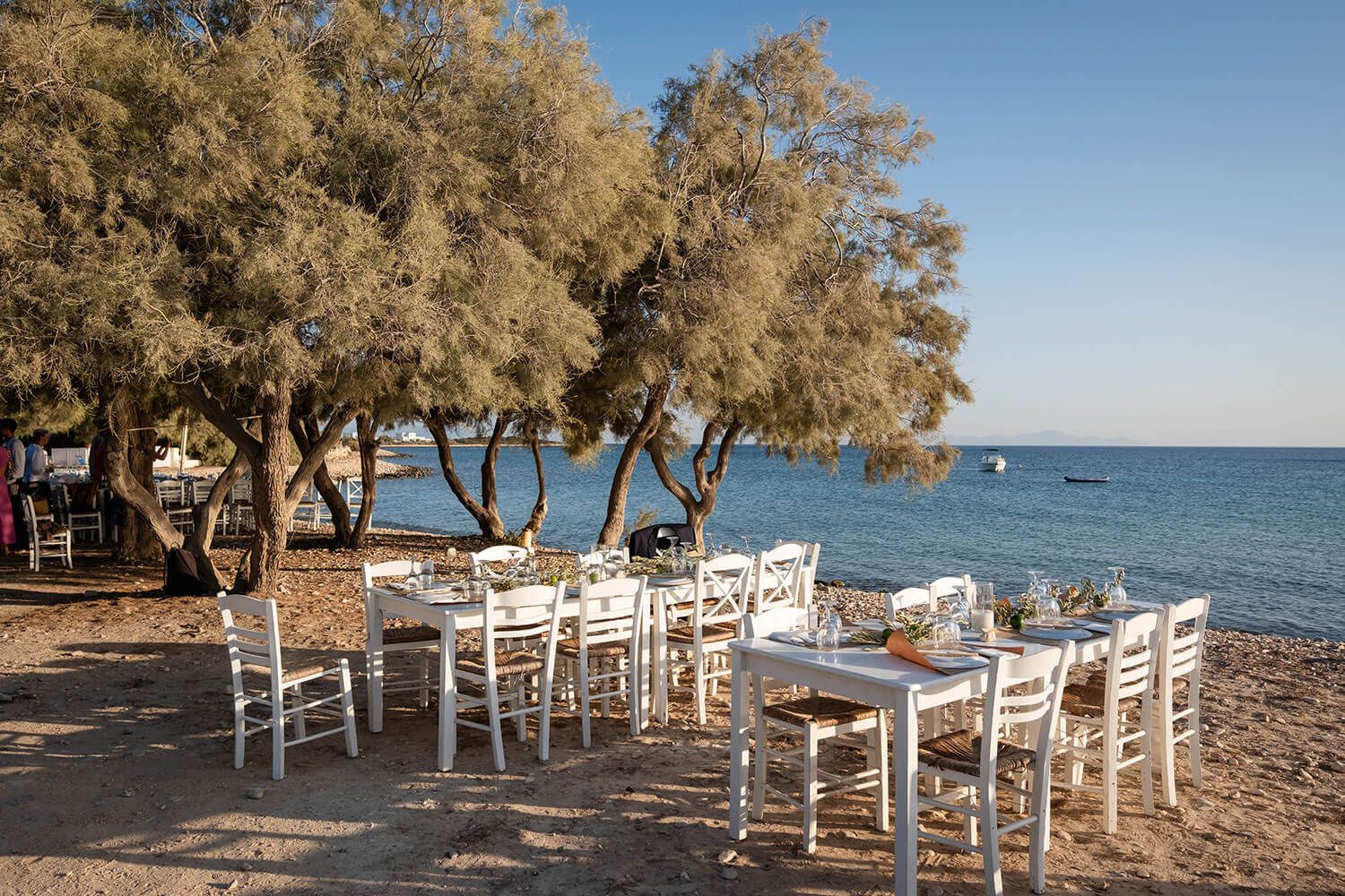 Warm Cycladic sunset during a pre-wedding beach gathering in Aliki