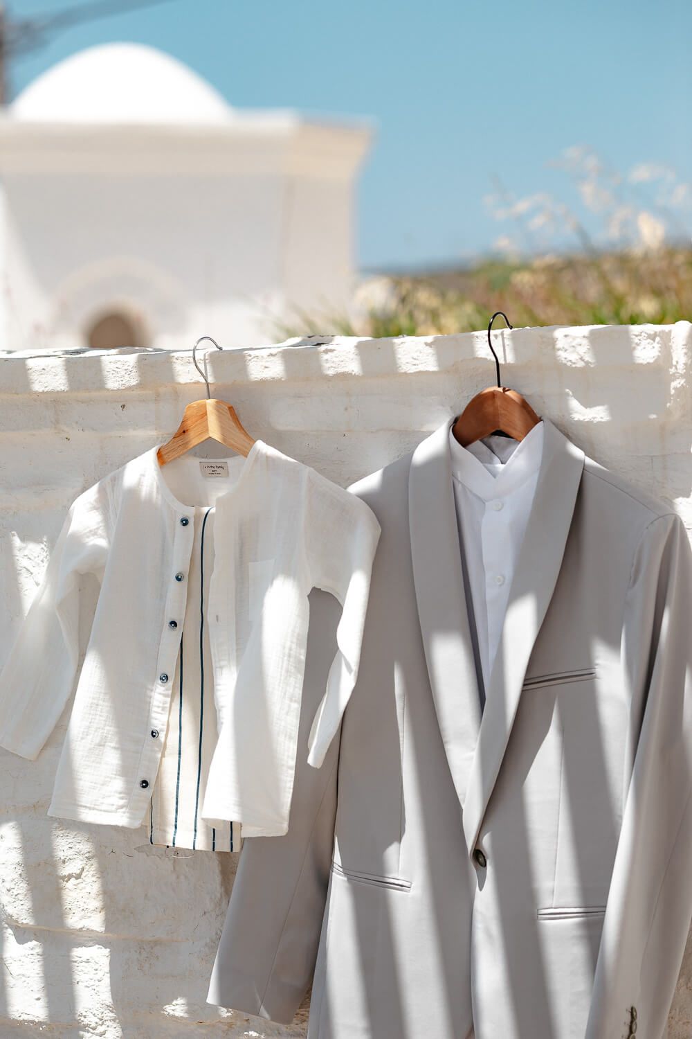 Detail shot of the groom's suit and accessories for a formal Paros wedding