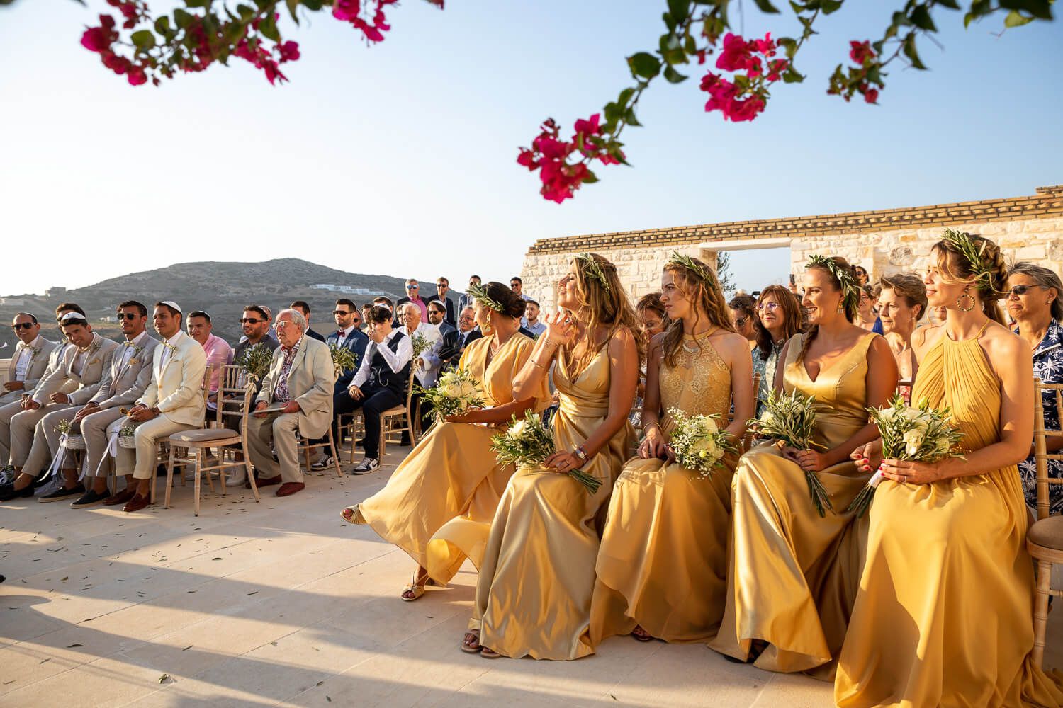 Outdoor Chuppah ceremony with red flowers and sea background