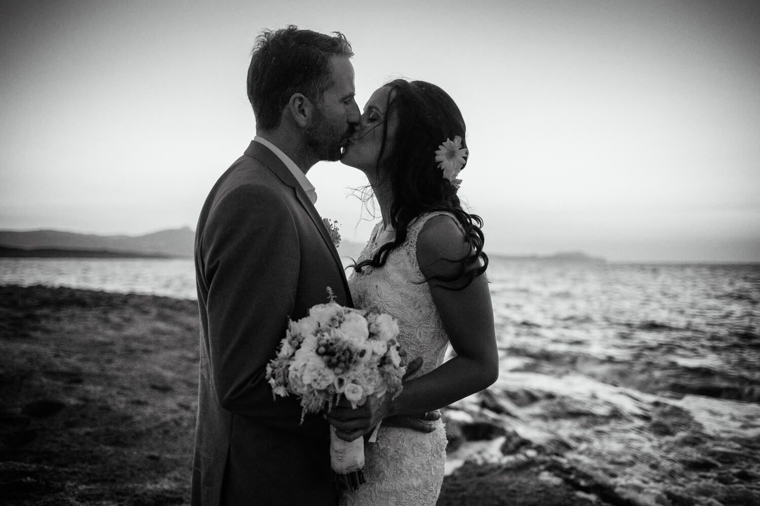 Romantic couple portrait with volcanic rocks background in Milos