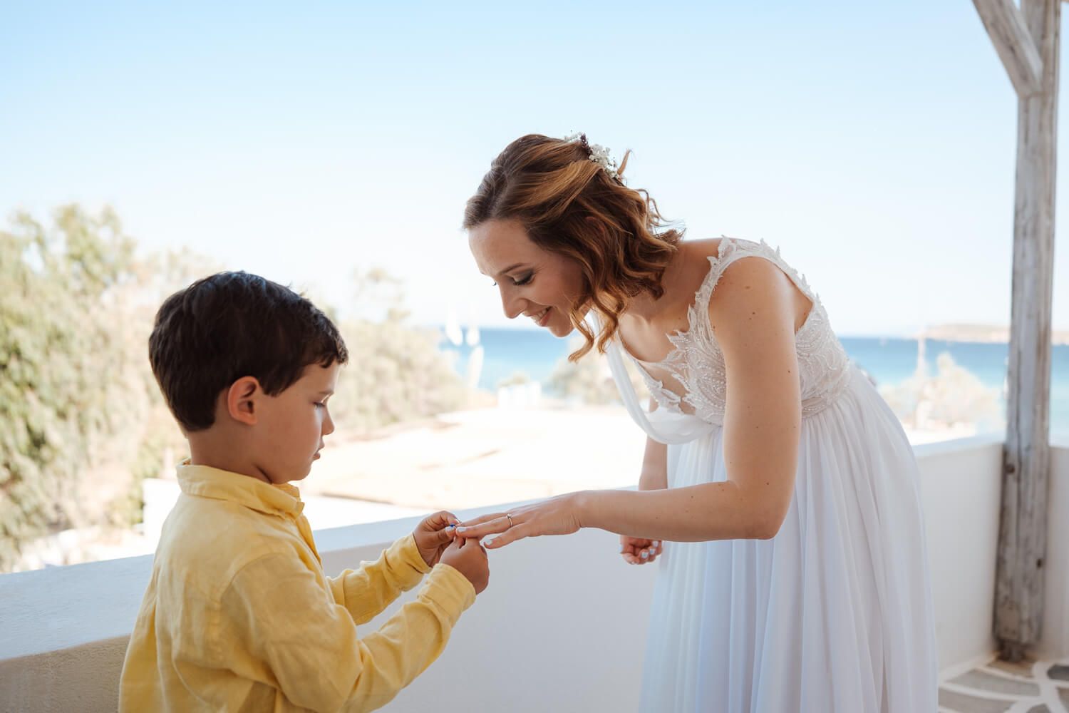 Bride Ioanna receiving a gift  at Louridis Studios in Paros