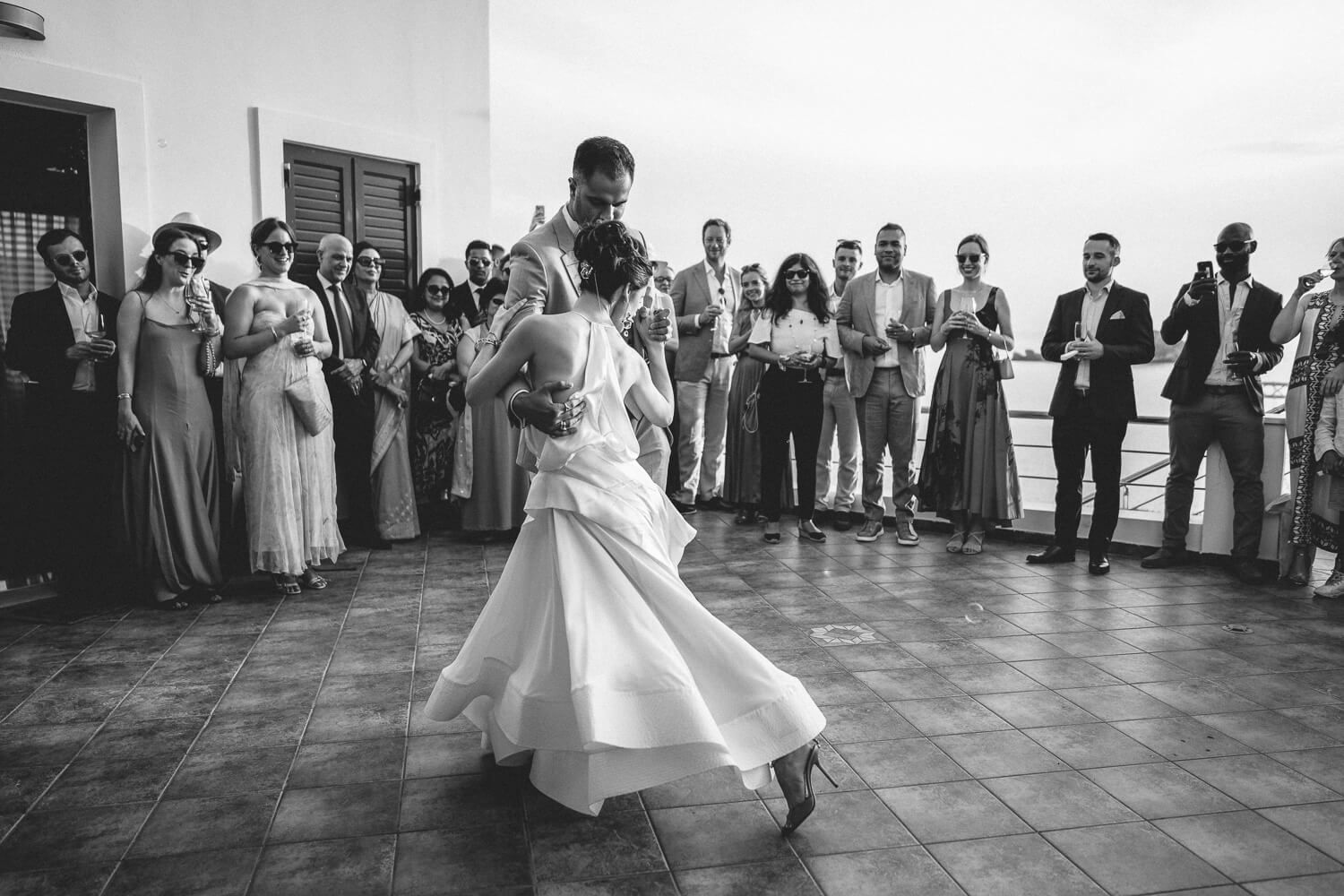 Newlyweds dancing in front of guests at Villa komito